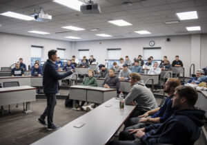 UMW alumnus Jin Wong speaks to the Mary Washington baseball team in the Leigh Frackleton Classroom in the College of Business. Photo by Tom Rothenberg.