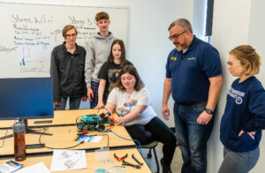 A team from Bridging Communities STEM Academy in New Kent, Virginia, collaborates on the best way to complete the mission. Photo by Dave Ellis.