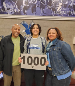 Jordan Carpenter poses with her parents inside UMW's Anderson Center. Carpenter - who amassed a string of honors with Mary Washington's women's basketball team - scored a buzzer-beating basket earlier this year, which propelled her into the 1,000-Point Club.