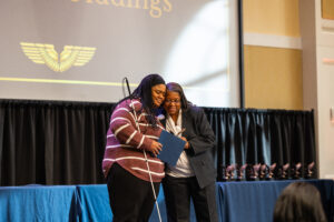 Adrianna Giddings receives the James Farmer Defining a Legacy Award from James Farmer Multicultural Center Director Marion Sanford. The award recognizing Giddings for a direct action project, overcoming obstacles, challenging oppressive systems and spreading her cause. Giddings was also a finalist for the Grace Mann Launch Award.