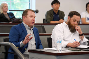 Andrew Blate '94 (left) and business partner Craig Schneibolk of Beautiful Home Services share their opinions with business student presenters at the Case Competition. The two sponsor the competition and started an endowed fund to cover the annual award money, totalling $5,000. Photo by Suzanne Carr Rossi.