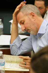 Lou Marmo '94 goes over the notes he took during each student-team's presentation during the College of Business Case Competition. Photo by Suzanne Carr Rossi.