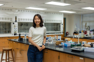 Lee poses inside a lab at the Jepson Science Center, where she's spent much of her Mary Washington career as a biochemistry major. Lee received early admission as a UMW sophomore to The George Washington School of Medicine and Health Sciences. Photo by Sam Cahill.