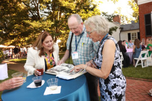1979 graduates peruse a Battlefield yearbook during the welcome reception at Brompton on Friday. Photo by Karen Pearlman.