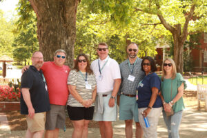 1994 graduates, who celebrated their 30th reunion, pose for a photo under the shade of trees along Campus Walk. Photo by Karen Pearlman.