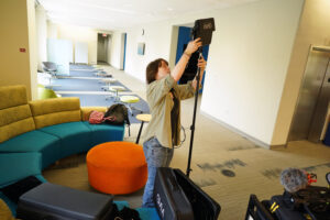 Senior Rob Willcox adjusts equipment inside UMW's Hurley Convergence Center. Willcox and the other participants in a five-week filmmaking session - part of AHSSSI - made videos of the other AHSSSI projects, as well as tackling other assignments. Photo by Suzanne Carr Rossi.
