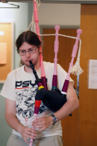UMW junior Donald Glander, a history and sociology major, helped the group study the history of the bagpipe and test their newly created instrument. Photo by Suzanne Carr Rossi.
