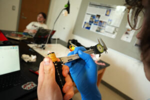 A member of the 3D bagpipe printing project takes measurements during the Arts, Humanities and Social Sciences Summer Institute. Photo by Suzanne Carr Rossi.