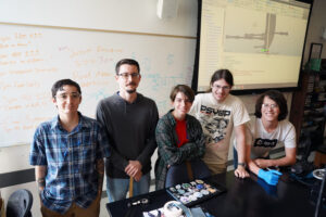 From left to right: Adjunct Music Instructor Rebecca Callaway poses with UMW students Daniel Paluh, James Turgeon, Donald Glander and Joe Haun. The group used a 3D printer to construct a bagpipe from scratch during the Arts, Humanities and Social Sciences Summer Institute. (Not pictured is Eagle Pipe Band Interim Conductor Olivia Corcoran.) Photo by Suzanne Carr Rossi.