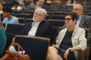 UMW Professor of Geography Steve Hanna and UMW Professor of Historic Preservation Christine Henry listen to remarks inside UMW’s Dodd Auditorium before the presentation. Hanna and Henry, who recruited UMW students to do research and work contributing to the Fredericksburg Civil Rights Trail project, also spoke at the event. Photo by Karen Pearlman.