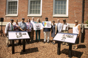 A group poses during the unveiling of two of five markers on the University of Mary Washington campus that are part of the Fredericksburg Civil Rights Trail. Pictured from left to right are: John White, Eunice Haigler, Frank White, Fredericksburg Mayor Kerry Devine, UMW Professor of Geography Steve Hanna, City of Fredericksburg Tourism Stadium and Sales Manager Victoria Matthews, UMW James Farmer Multicultural Center Assistant Director Chris Williams, UMW Professor of Historic Preservation Christine Henry, UMW President Troy Paino, Sherman White and Kaye Savage, Mary Washington's first Black residential student. Photo by Karen Pearlman.