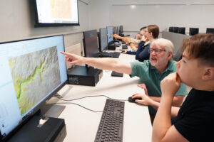 Professor of Geography Steve Hanna works with UMW Noyce Scholar Nolan MacDiarmid on Adventures in Mapping. Photo by Suzanne Carr Rossi.