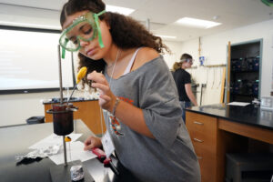 Darla Smith starts an experiment in Polymers, Plastics and Me. Photo by Suzanne Carr Rossi.