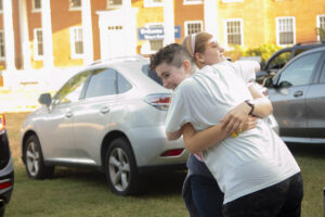 First-year student Alexandra Fisher, who hopes to study political science at Mary Washington, receives a big hug on Move-In Day. Photo by Karen Pearlman.