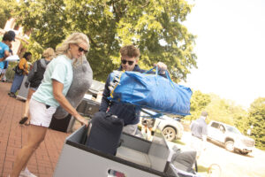 Nathan Krueger came from Pasadena, Maryland, to play lacrosse at UMW. Here, his mom, Marlene Chamberlin, helps him load his belongings to move into his room in Randolph Hall. Photo by Karen Pearlman.