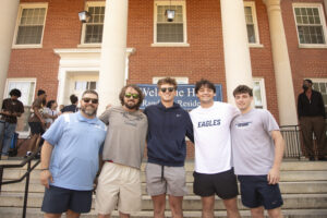 Nathan Krueger (center) poses with members of the UMW Lacrosse team, who greeted him on Move-In Day. Photo by Karen Pearlman.