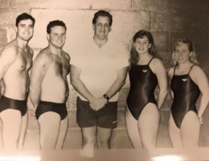 Evan Stiles (second from left) poses with fellow Mary Washington swim team captains. Stiles, who earned a degree in geography from Mary Washington in 1991, has coached Olympic gold-medalist swimmer Torri Huske for more than a decade.