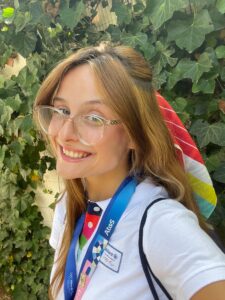 Recent UMW graduate Hadley Mantia '24 shows off the uniform she wears to greet spectators flying to Paris from all over the world. Mantia works in hospitality for major Olympics sponsor Allianz.