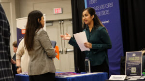 A student talks to a prospective employer aat the recent Career and Internship Fair, hosted by UMW's Center for Career and Professional Development. Photo by Jordan Beaupre.