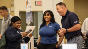 A student talks to prospective employers during the UMW Center for Career and Professional Development career fair, held in the Cedric Rucker University Center's Chandler Ballroom. Photo by Jordan Beaupre.
