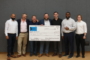 From left to right: Sudhanshu Sarin, Travis Bjorklund, Andrew Blate, Craig Schneibolk, Jeremy Sanchez, Dwayne Clarke and Cole Hudak pose during UMW's fall 2024 College of Business Case Competition. Blate, who graduated from UMW in 2004, and Schneibolk created the endowed fund for the competition's annual award money and served as judges, along with Bjorklund. Sarin, Sanchez, Clarke and Hudak, all UMW business students, teamed up for a first-place finish. Photo by Karen Pearlman.