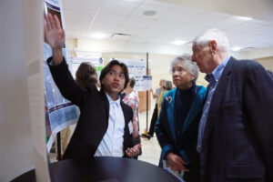 Edmund Garcia ’26, recipient of the Molly Bradshaw Clark ’59 Scholarship, chats with Emily Lewis ’62 and Anthony Andres during the Student Showcase. Photo by Karen Pearlman.