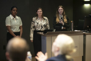 From left to right: UMW seniors Helen Worku, Taylor Munger and Katie Reif present their first-place project, FlossyPik, a new take on dental flossers for which the group plans to apply for a patent. Photo by Karen Pearlman.