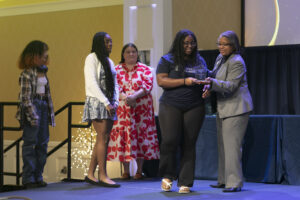James Farmer Multicultural Center Director Marion Sanford (far right) presents the Eagle Award for Outstanding Diversity Program, which went to the UMW Black Student Union's Kwanzaa. Photo by Karen Pearlman.