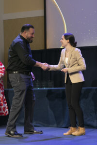 Bachelor of Liberal Studies Associate Director Kristen Fairbanks presents UMW senior Justin Whoerle with the UMW Alumni Association Distinguished Bachelor of Liberal Studies Award. Whoerle was the first winner of the award to complete degree requirements completely online. Photo by Karen Pearlman.