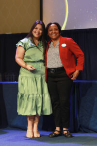 Dean of Students and Associate Vice President for Student Affairs Melissa Jones (right) presents Residence Life and Housing Area Coordinator Laura Gilchrist-March with the Cedric Rucker Eagle Beyond Compare Award for faculty and staff. Photo by Karen Pearlman.