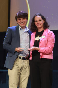 Vice President for Student Affairs Juliette Landphair presents the Prince Woodard Outstanding Leader Award to Shadwick Yoder. Photo by Karen Pearlman.