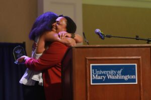 Dean of Students and Associate Vice President for Student Affairs Melissa Jones (right) hugs UMW senior Martina Nicholson, who not only co-hosted Eagle Awards but also won the night's most coveted honor, the Grace Mann Launch Award. Photo by Karen Pearlman.