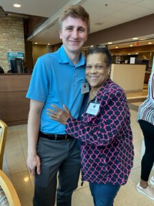 Eunice Haigler, a member of the Stafford African American Heritage Trail Advisory Committee, hugs UMW student Ethan Sweeny, who played an instrumental part in designing the maps that make up the trail's online presence.