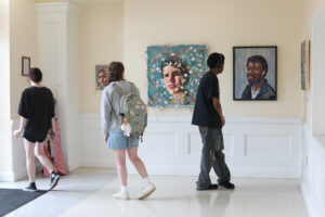 First-year students Caitlyn Faris, Morgan Hamm and Kaleb Fallen check out the studio art exhibition on display in the Cedric Rucker University Center. Photo by Karen Pearlman.