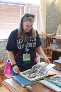 An alumna flips through a Battlefield Yearbook in the Special Collections and University Archives room at Simpson Library, which will be open Friday and Saturday. Photo by Karen Pearlman.