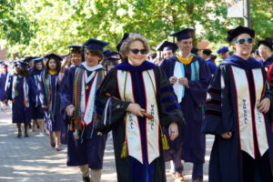 Faculty and students process along Campus Walk during the University of Mary Washington's 114th commencement ceremony on Saturday, May 10. More than 900 students received bachelor's and master's degrees during the three-hour event. Photo by Suzanne Carr Rossi.