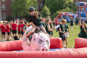 A variety of lawn games and inflatables, including a mechanical bull-type ride called Harley the Hog, comes to campus for the annual Devil-Goat Day event. Photo by Parker Michels-Boyce.