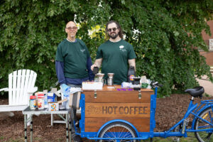 From left: Ray Tuttle, UMW’s health promotions and student success specialist, and Devin Walsh, UMW’s peer recovery specialist, run Eagles in Recovery, a program that supports Mary Washington students working to overcome substance and alcohol addiction. A Fund for Mary Washington Impact Grant has supported Walsh’s position, which also oversees the recovery coffee bike (seen here), providing beverages, education and outreach to the campus community. Photo by Parker Michel Boyce.