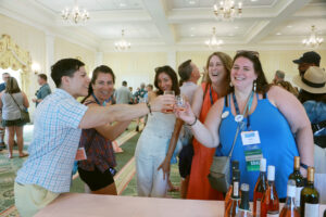 2014 alumni, including Director of Annual Giving Shelby Orlando '14 (right), sample Virginia vintages at the wine, beer and cider tasting during 2024’s Reunion Weekend. Photo by Karen Pearlman.