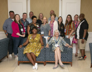 Past and present members of the Alumni Association Board of Directors pose for a photo with Executive Director of Alumni Engagement Mark Thaden '02 (back row, far left) and Vice President for Advancement and Alumni Engagement and UMW Foundation Executive Director Katie Turcotte (back row, center left) at Reunion Weekend in 2024. Photo by Karen Pearlman.