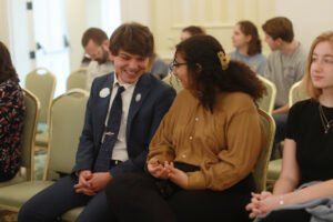 Shadwick Yoder ’25, vice president of the Student Government Association, and Amira Said ’26, UMW Senate vice president, chat in between presentations, while Callie Harkins ’26 (right), editor of The Weekly Ringer student newspaper, looks on. Photo by Karen Pearlman.