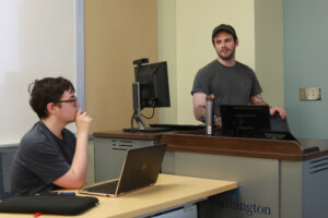 Senior music major Patrick Lynch takes a question from senior computer science major Victor Rahman during the oral presentations portion of Research and Creativity Day inside the Hurley Convergence Center. Photo by Karen Pearlman.