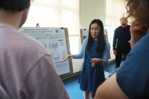 Mary Washington junior Mallory Thompson presents her research poster at UMW's Research and Creativity Symposium held each year on the last day of classes. Photo by Karen Pearlman.