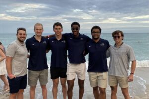 Diederich with the men's swim team Class of 2025 at the team's winter training trip.