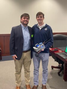 Thompson poses here with his brother, Reed, and a detection and survey prototype built by a small team he managed during a summer internship with a national defense contractor.