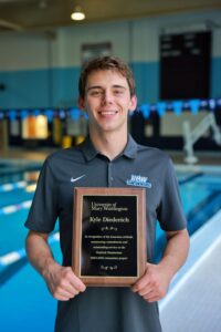 Senior Kyle Diederich displays the commemorative plaque he received for his contributions to the Goolrick Pool renovation project, an initiative he took on in addition to his studies as a business administration major and sports management minor while also competing on the varsity swim team. Photo by NAME.