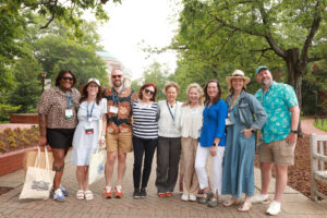 Rachel Selle '05 (second from left) and fellow 2005 alumni join 1980 alumni for a photo on Campus Walk during Reunion Weekend. This year's event celebrated classes ending in 0 and 5, but all graduates are welcome to participate in the annual celebration held at the end of May. Photo by Karen Pearlman.