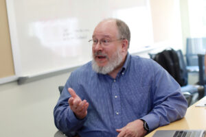 Associate Professor of Linguistics Paul Fallon explains his group's AHSSSI project. Photo by Karen Pearlman.