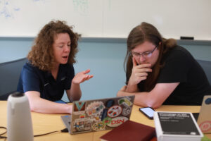 Digital Knowledge Center Associate Director Shannon Hauser (left) works with UMW senior Michael Boehmcke inside the Hurley Convergence Center. Hauser was recruited for her technical expertise to assist with the AHSSSI project, 'Atoms of Sound: An Encyclopedia of Phonological Features,' led by Associate Professor of Linguistics Paul Fallon. Photo by Karen Pearlman.