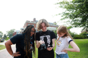 From left: Alanah Cleare '25, who earned a degree in marketing from UMW in May; junior Owen Wheeler; and senior Chloe Adler review recently captured footage for a project aimed at assessing the usefulness of AI in filmmaking. The trio conducted research under the guidance of Assistant Professor of Communication and Digital Studies J.D. Swerzenski. They were among four groups that participated in this year's Arts, Humanities and Social Sciences Summer Institute. Photo by Karen Pearlman.